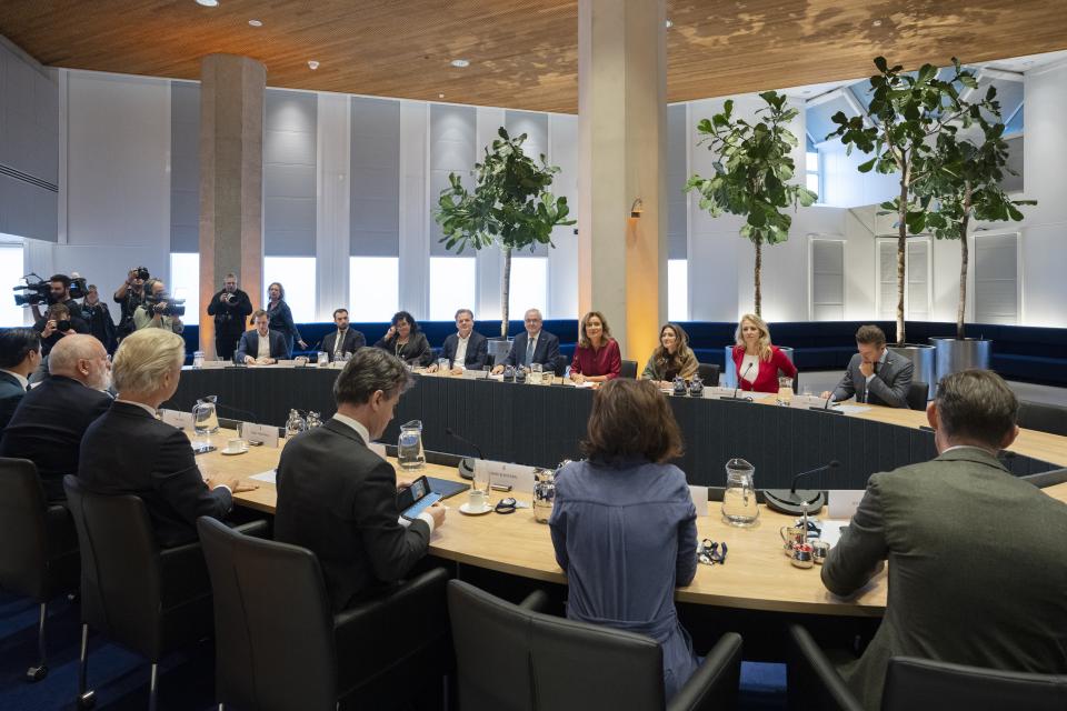 Kamervoorzitter Vera Bergkamp en de lijsttrekkers rond een grote ovalen vergadertafel