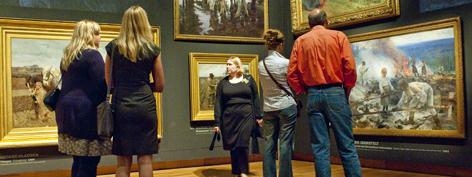 Personen bekijken schilderijen in een museum